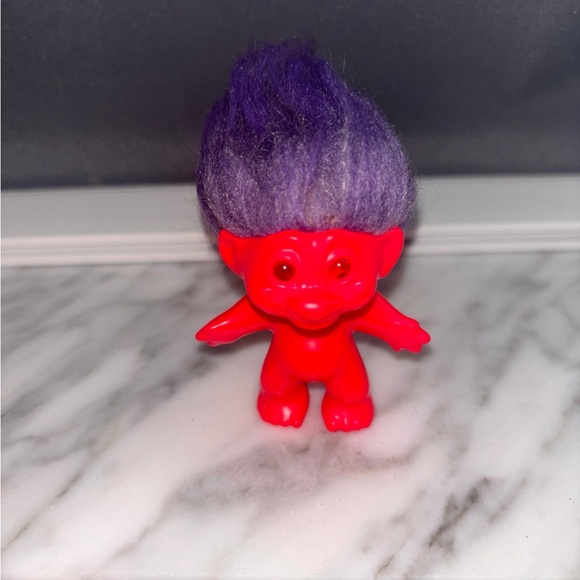 Vibrant Red Troll Figure with Striking Purple Hair